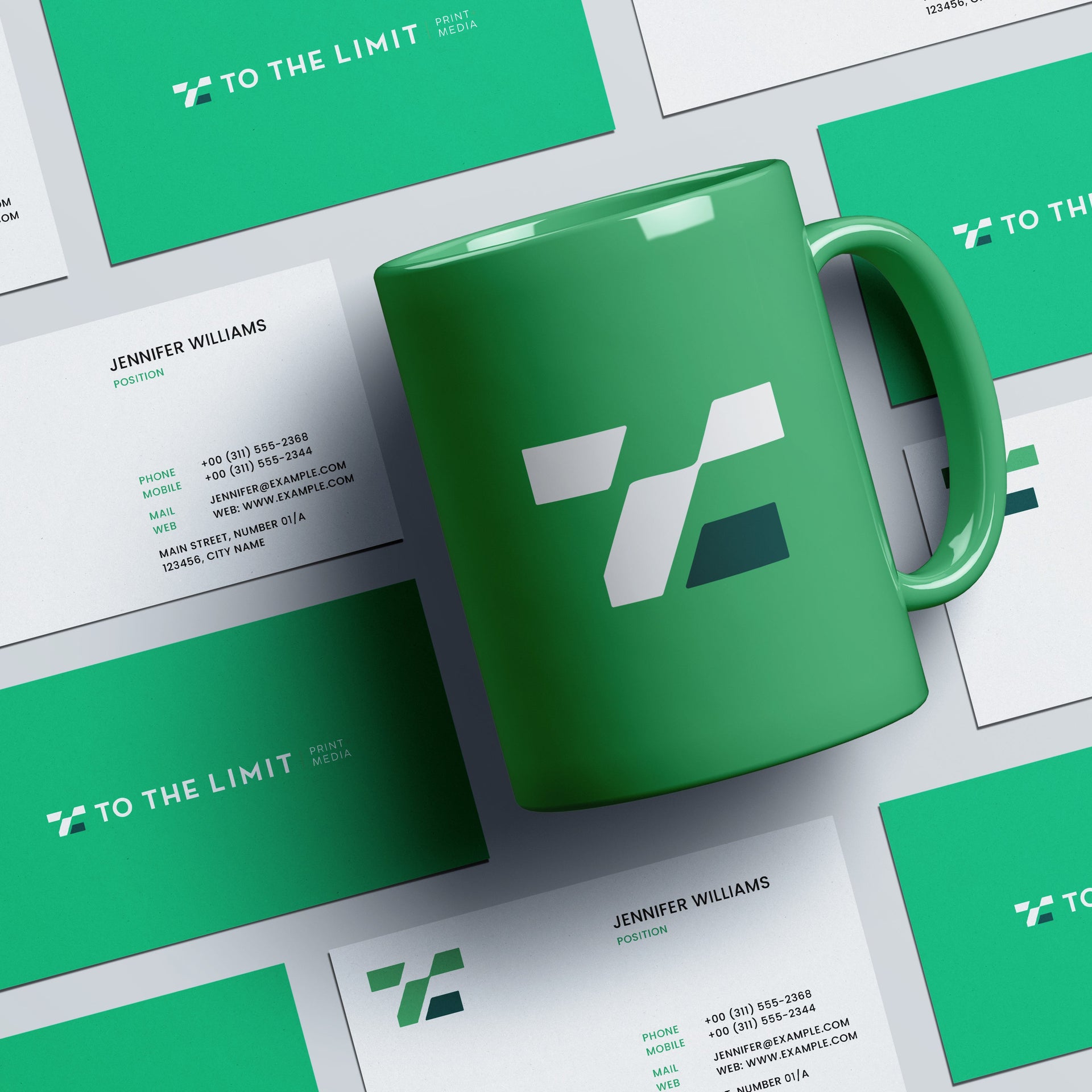 Green mug and business cards with 'To The Limit' logo on a white background
